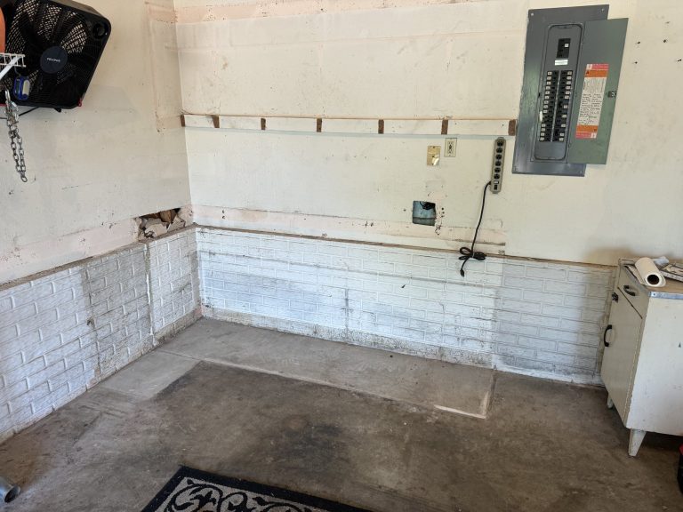 Garage workshop wall cleared after cabinet demolition and debris removal in Nixa