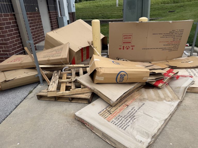 Cardboard and packing debris covering a Ross Dress for Less loading area before commercial cleanup